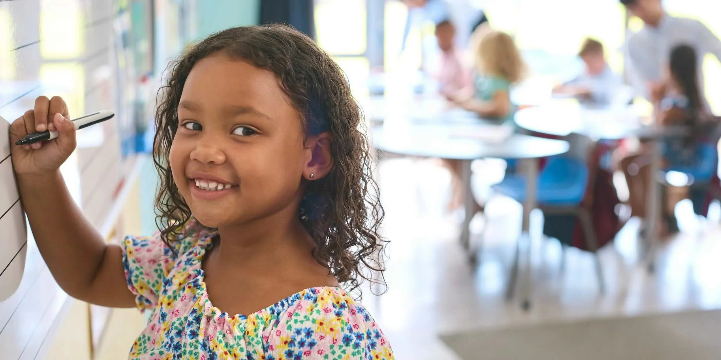 Young girl writes on a whiteboard. | Operation Shoestring | Community Foundation for Mississippi Grants