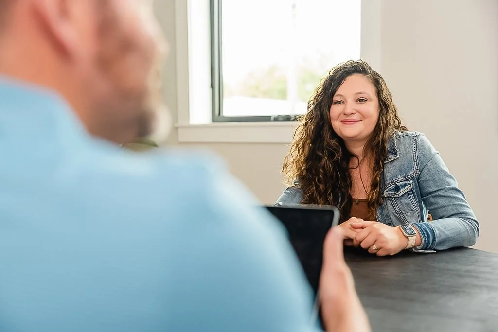 Close-up shot of a client talking with a Clukey & Tebault staff member.