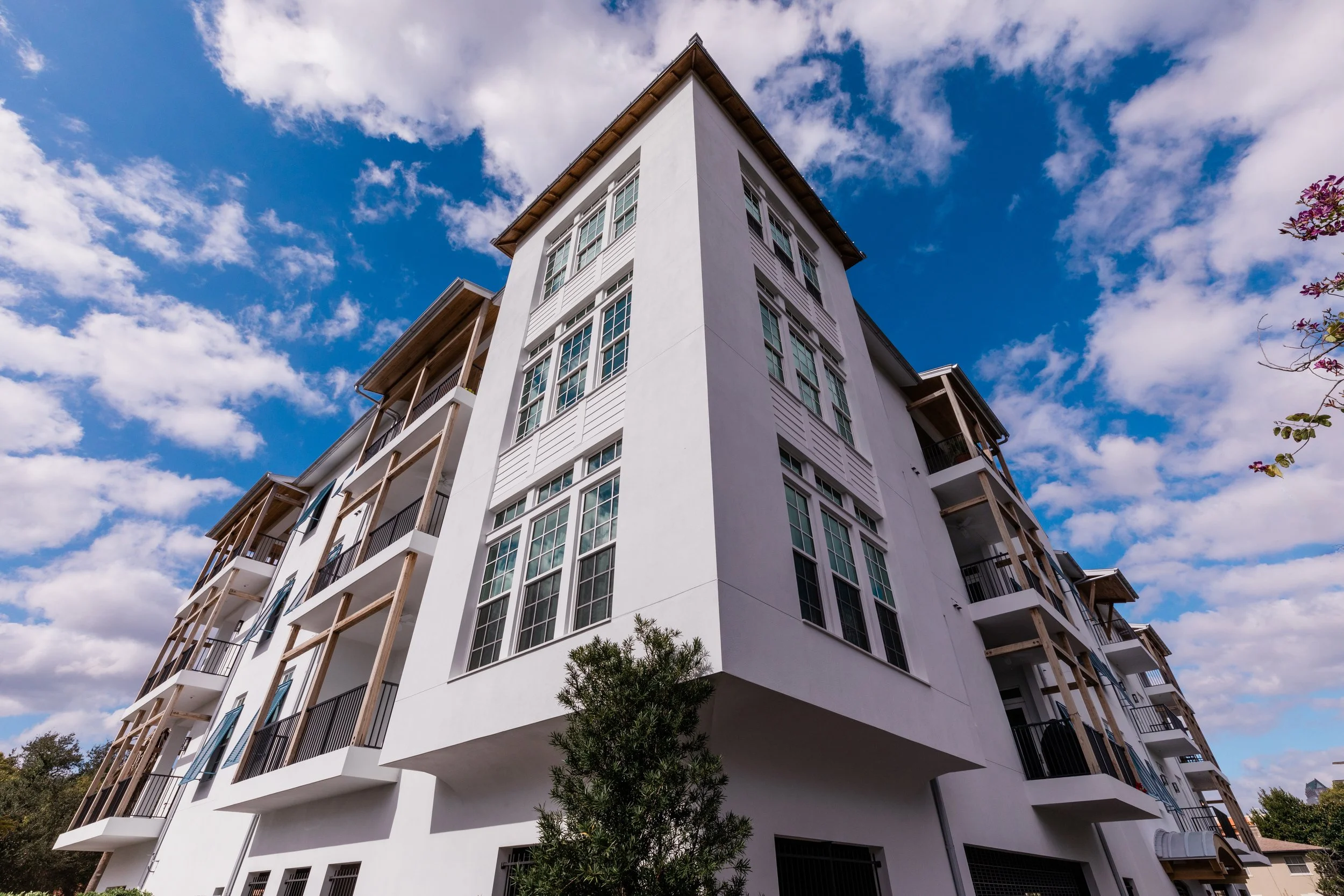 Mike Ruble architect designed this condo on Davis Islands. Corner perspective shot with blue skies and white clouds.
