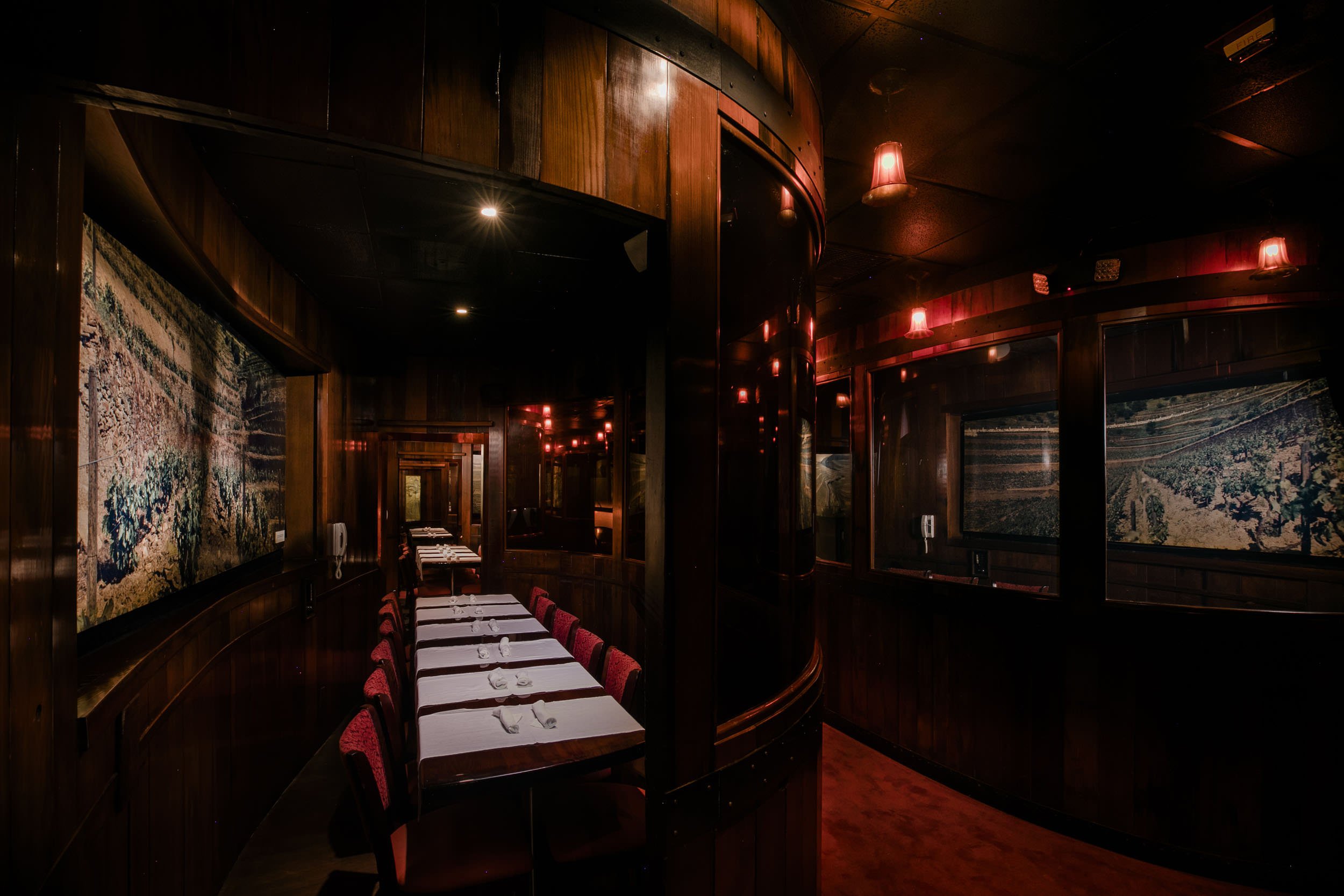 Port Room at Bern's Steak House, dark wood, red chairs and carpet, vintage vineyard photos on the walls