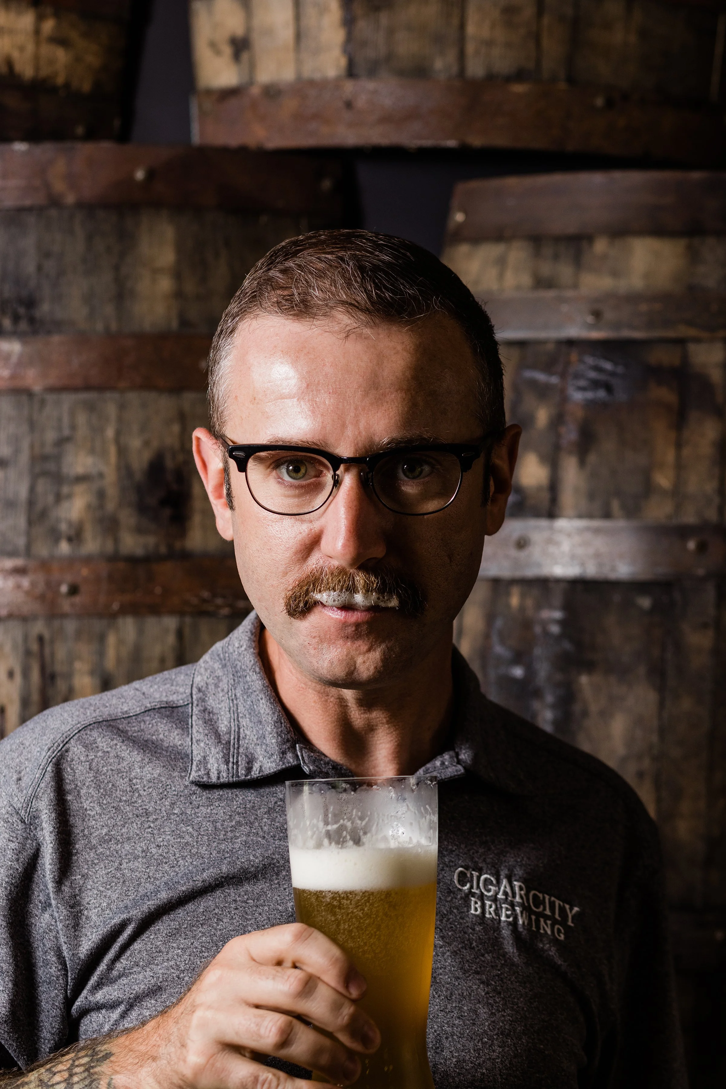 man with beer in hand and on his moustache at Cigar City Brewing