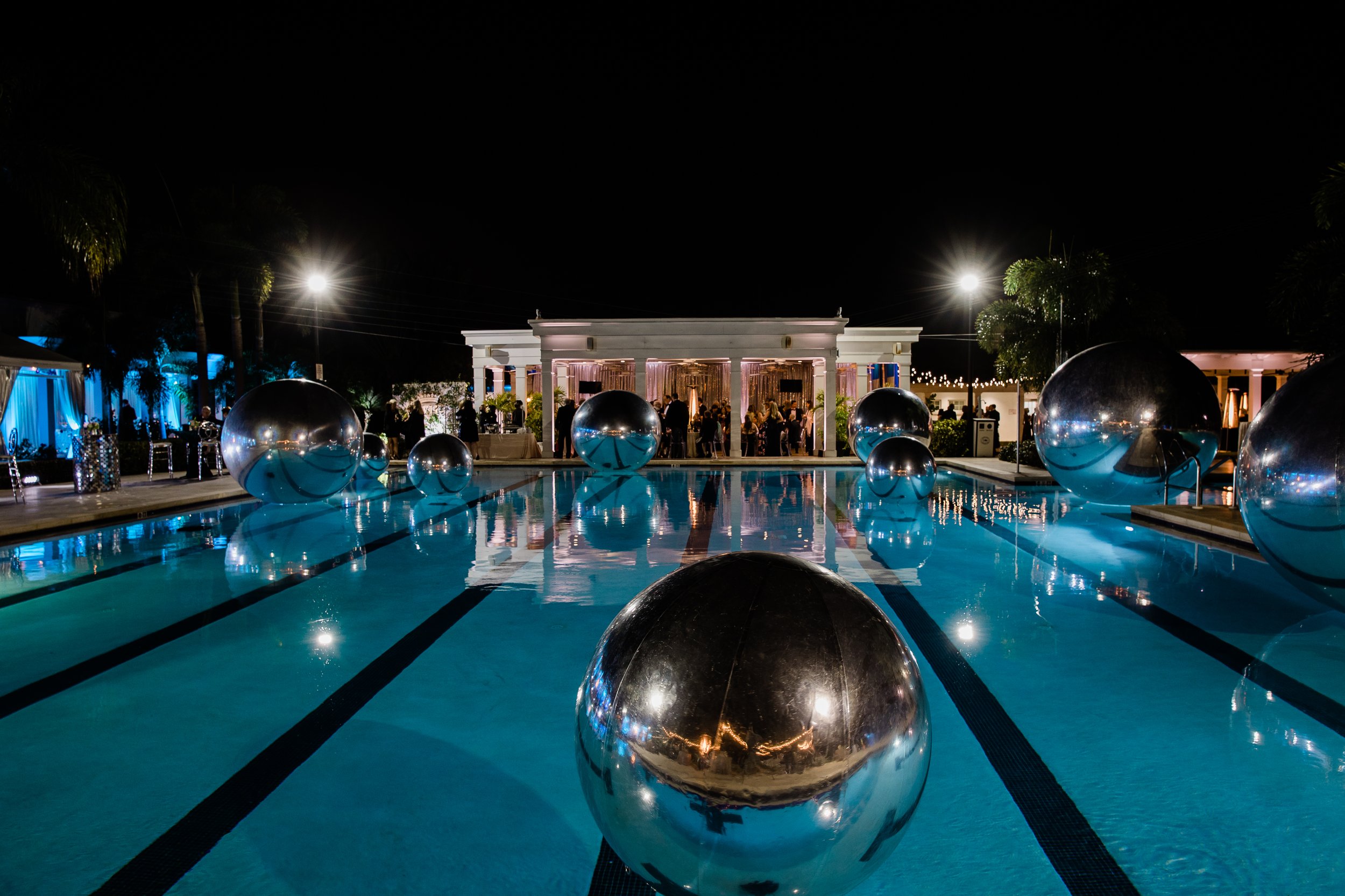 Silver balls float in the pool at TYCC for the Queen Gasparilla party
