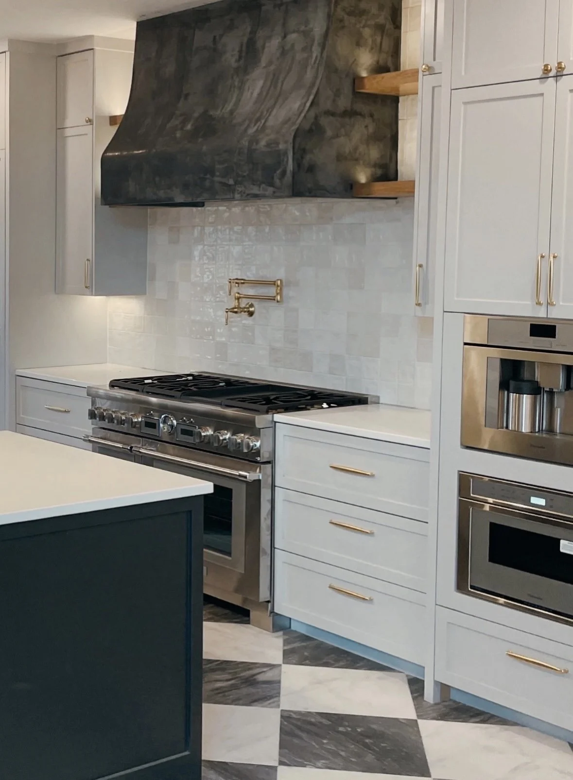 Zellige tile back-splash with custom made vent hood and checkered marble tile floors built in coffee maker and built in microwave floating shelves by Opal & Oak