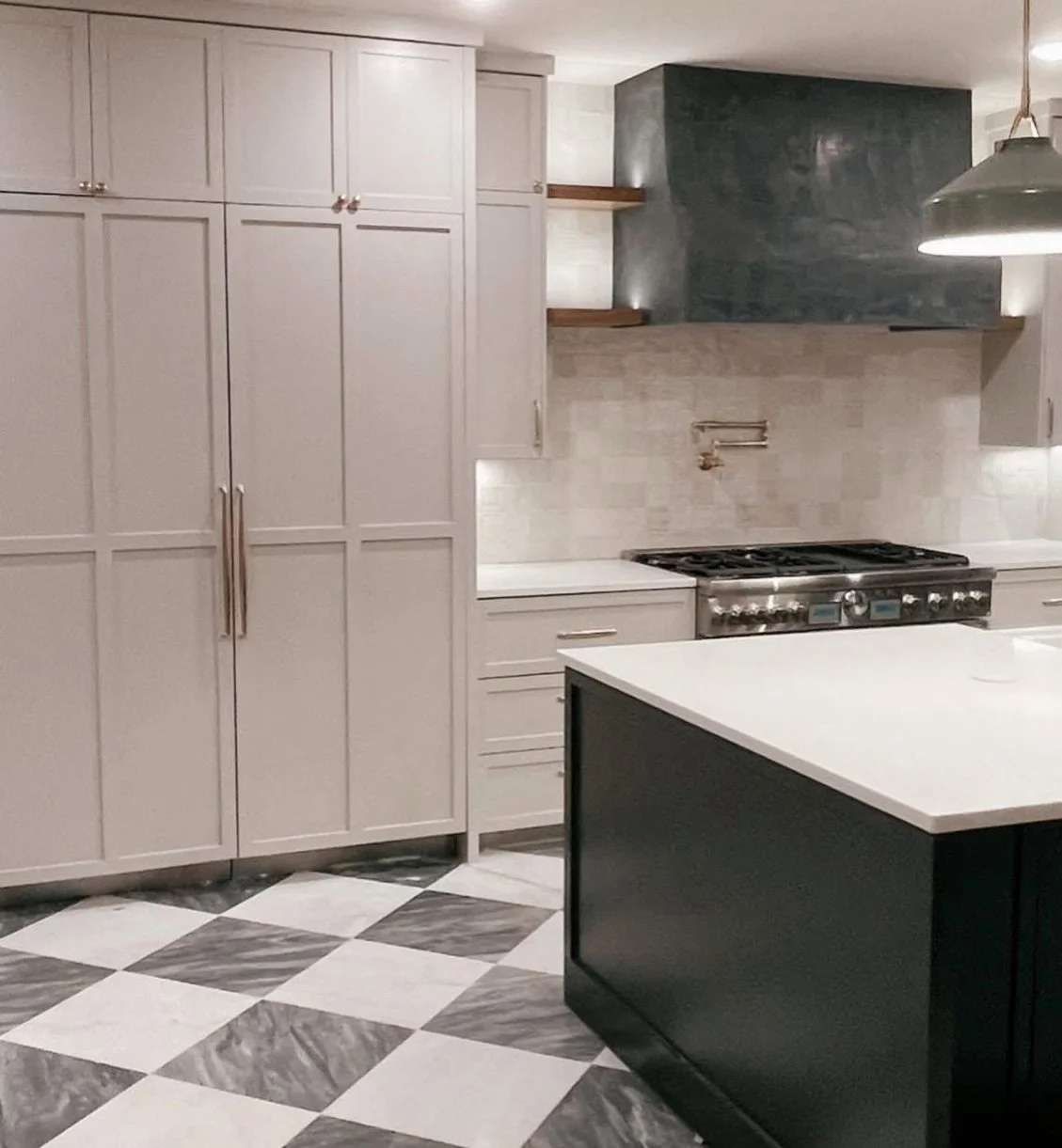 Kitchen remodel with checkered marble tile flooring, custom cabinetry, custom vent hood, built in fridge and freezer, brass hardware, and built in coffee maker by Opal & Oak.