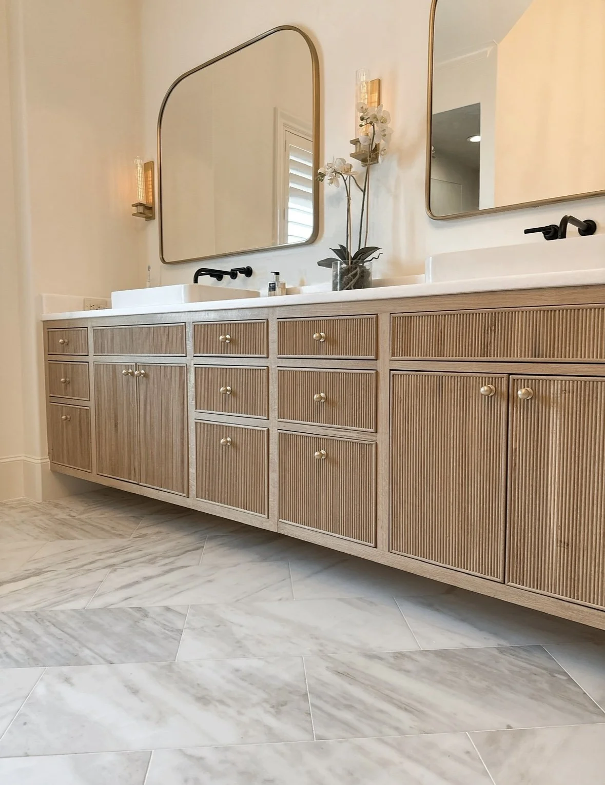 modern bathroom with custom cabinetry and calacutta marble floors by Opal & Oak