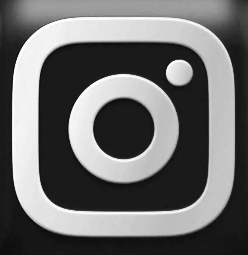 Close-up of the Instagram logo, a square camera icon with rounded edges, a circle in the center, and a small circle at the top right corner.