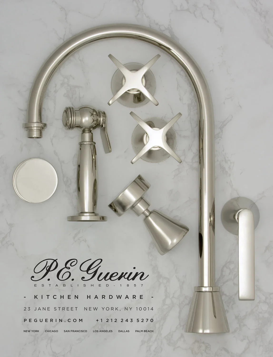 Metal kitchen faucet and hardware pieces on white marble surface with P.E. Guerin kitchen hardware label and contact information.