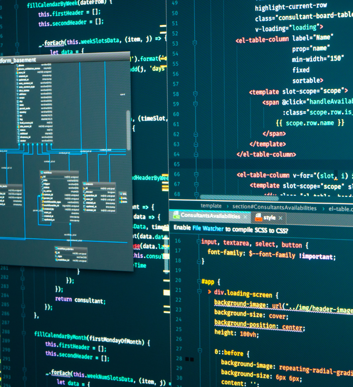 Close-up image of computer screens displaying programming code and system design diagrams, with multiple code snippets and flowcharts visible.