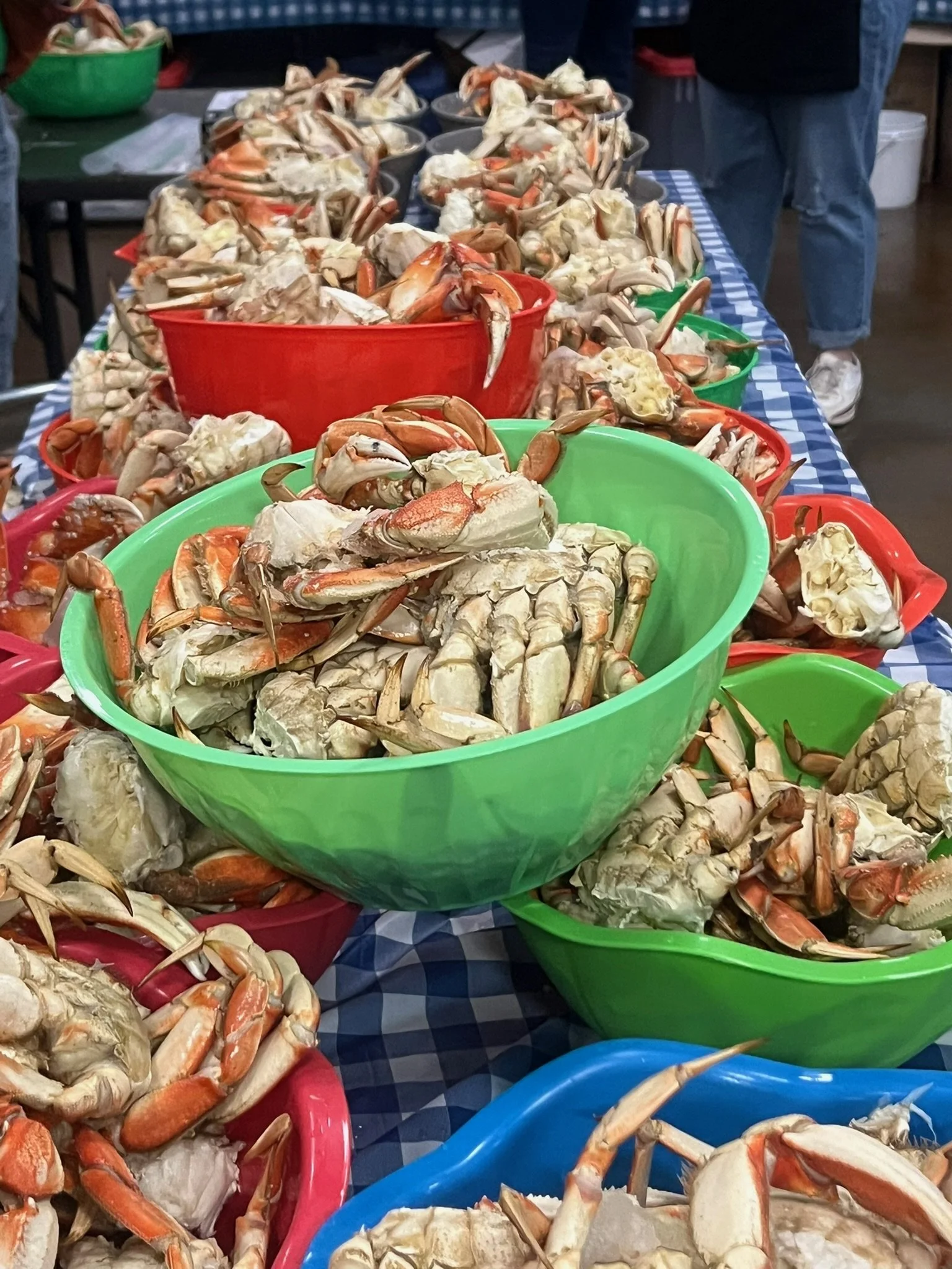 Baskets of cooked crabs on ice at a seafood market or stall.