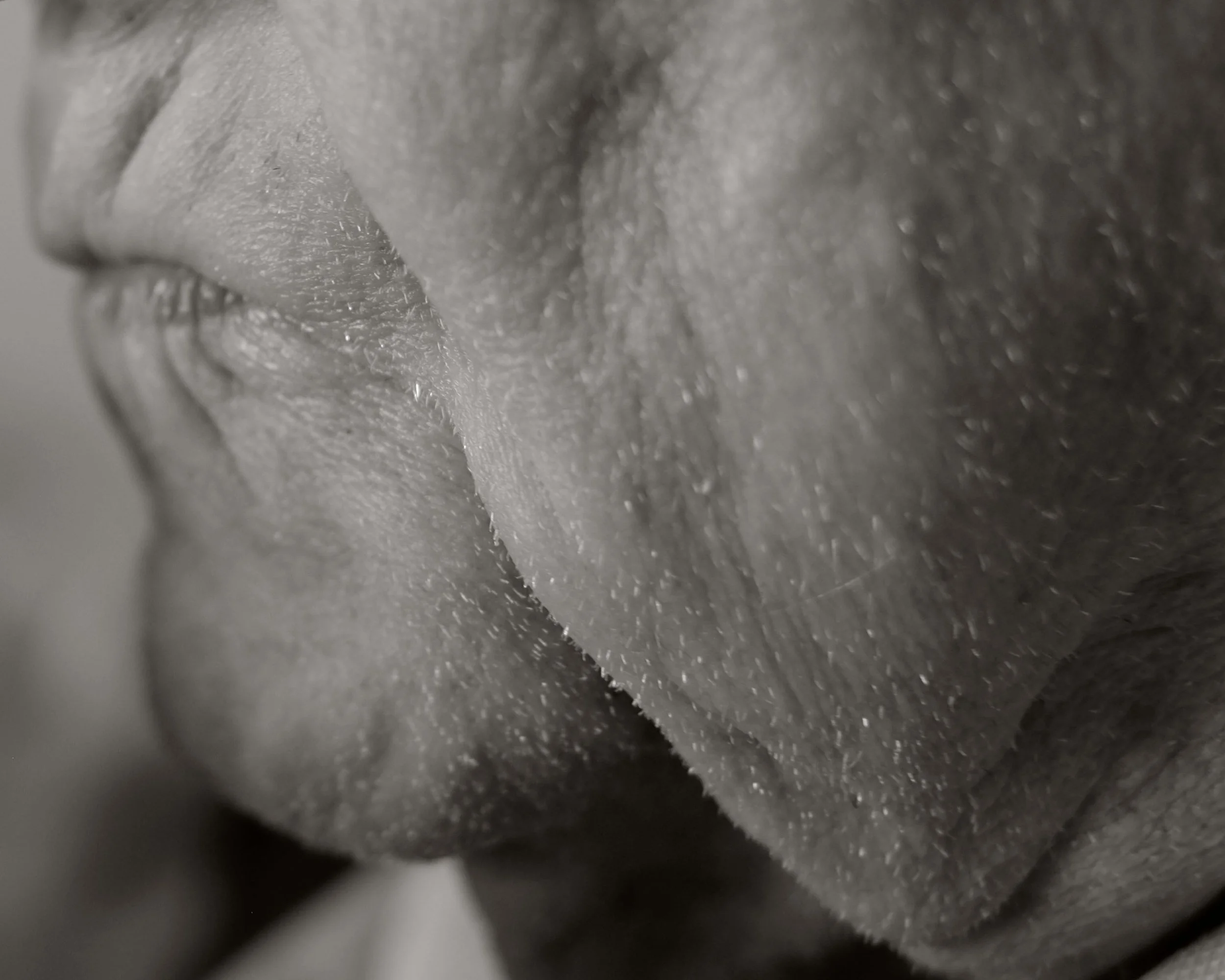 Close-up of a person's lips and nose in black and white.