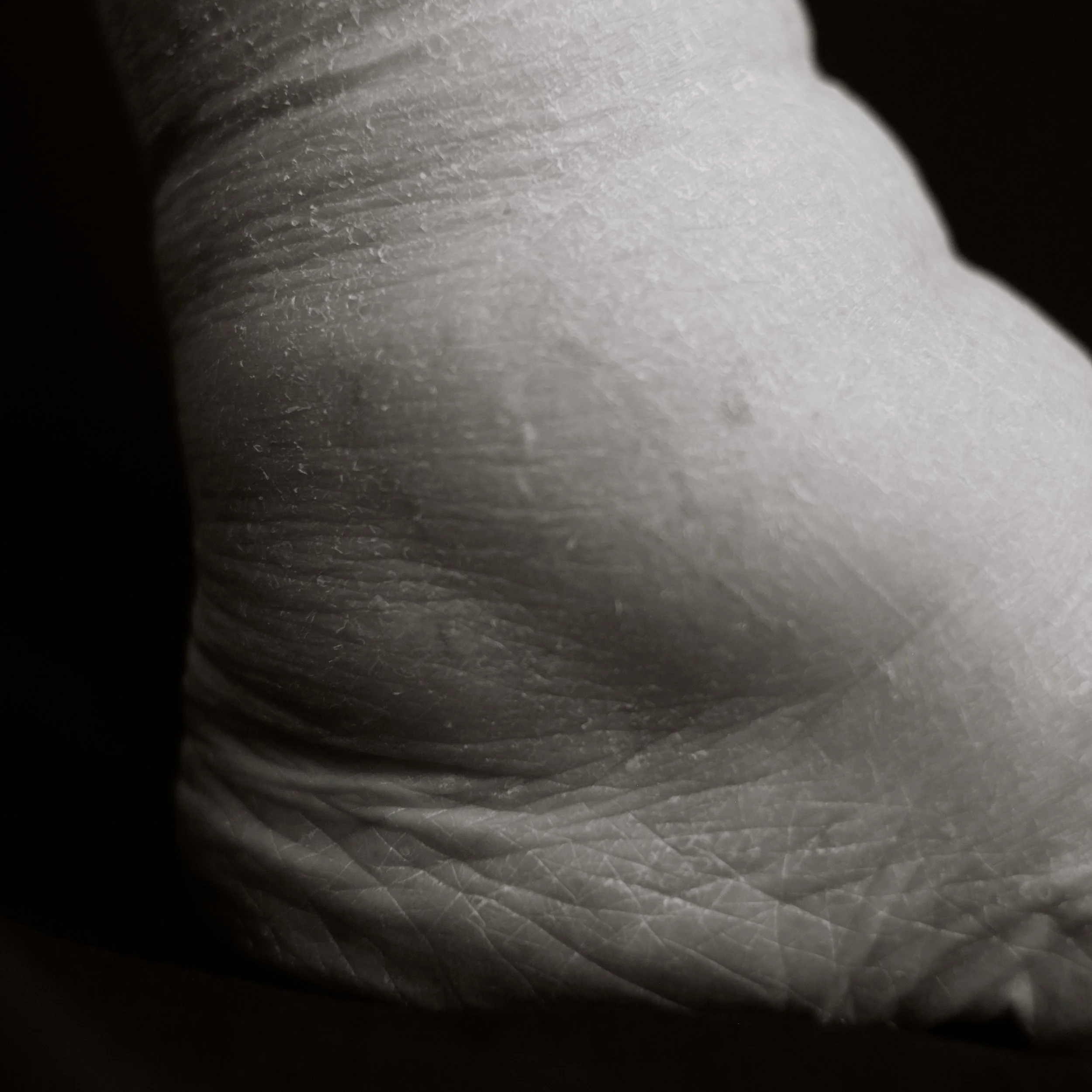 Close-up of wrinkled, textured skin, showing folds and creases of people over the age of 100
