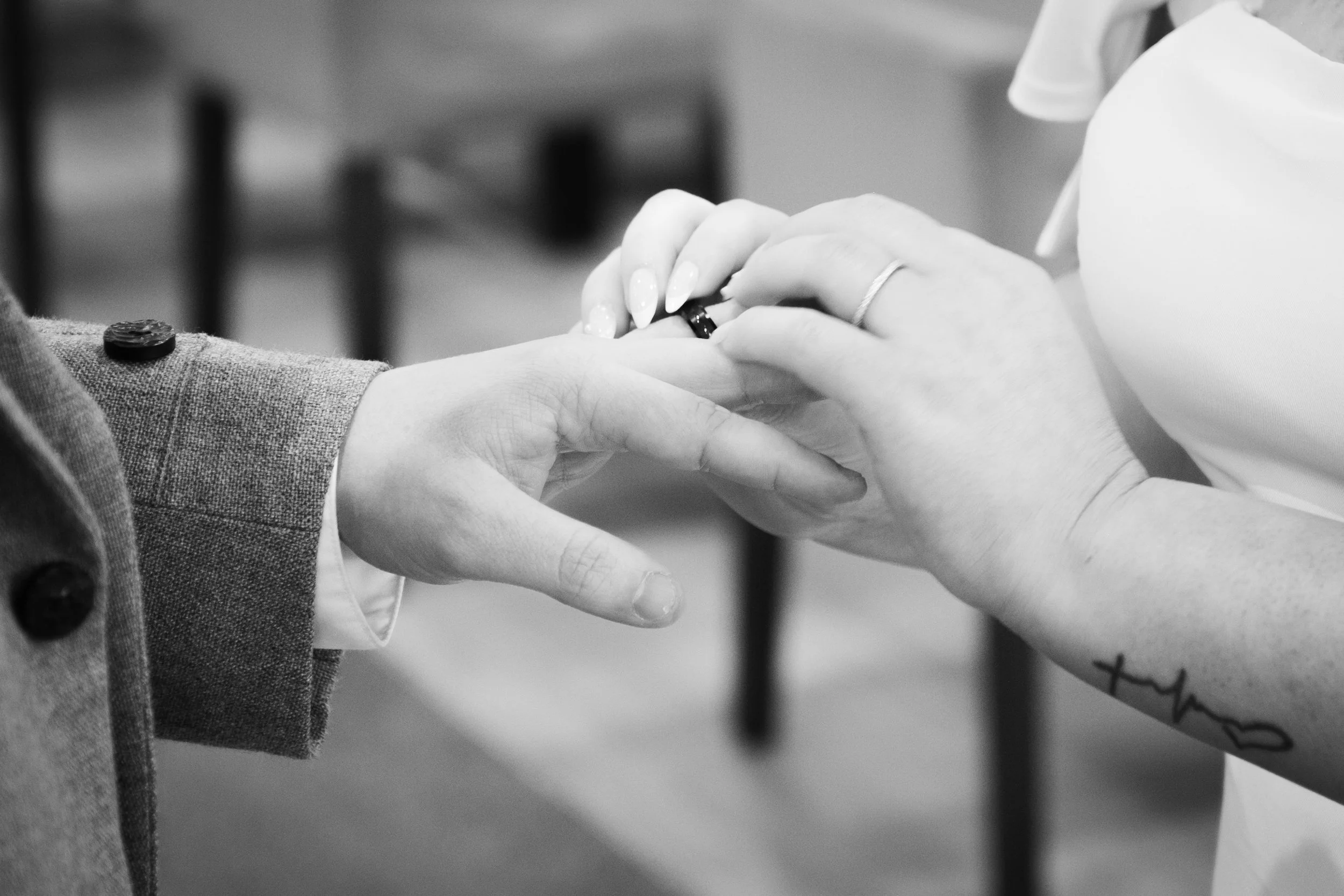 Charlie Black Wedding Photography -  Close-up detail of wedding ring exchange.
