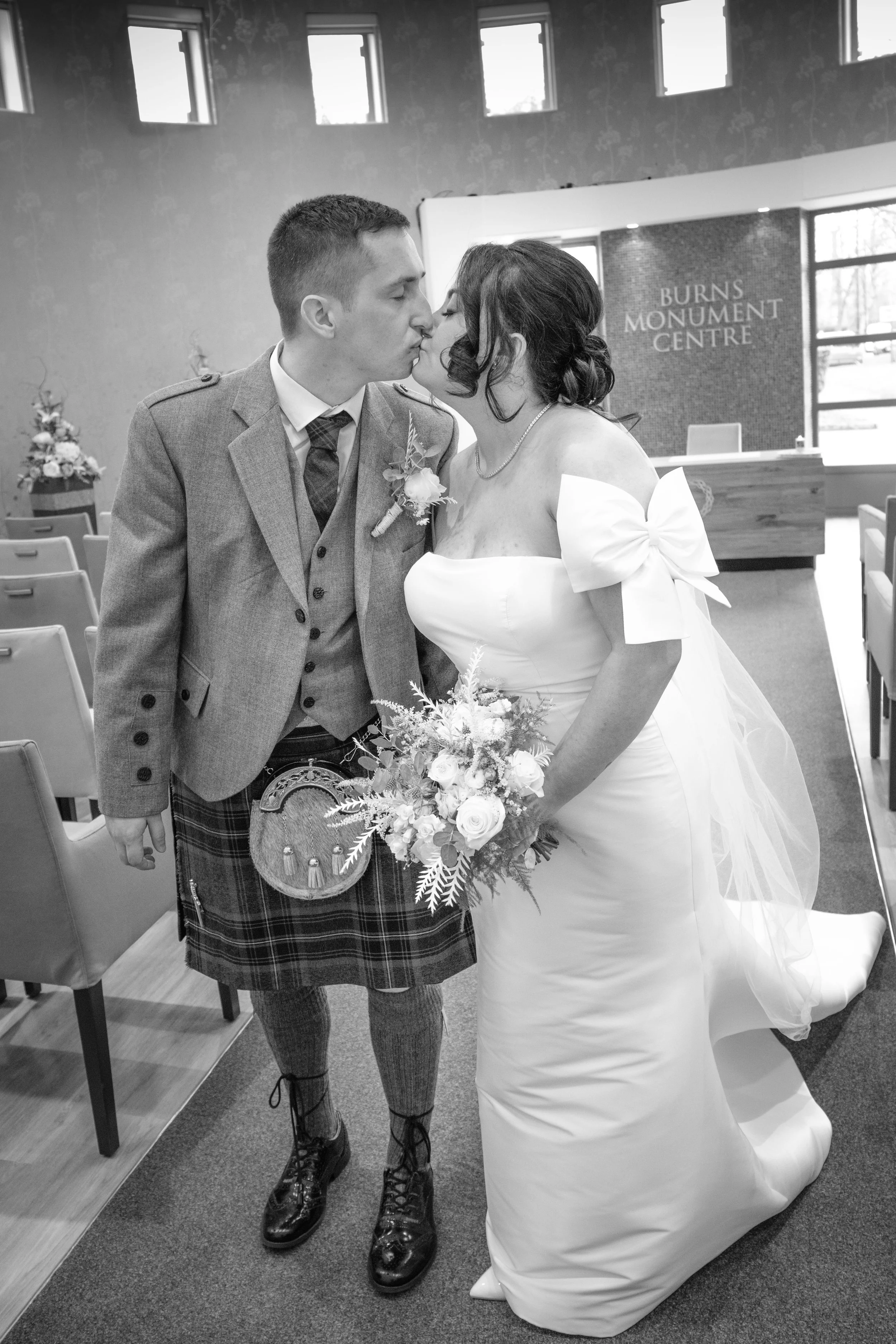 Charlie Black Wedding Photography - Candid cinematic shot of bride and groom walking down the aisle. 