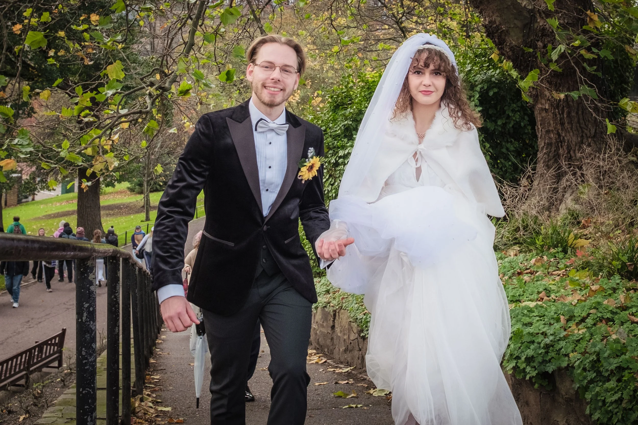 Charlie Black Wedding Photography - Candid moment of bride and groom walking in Edinburgh