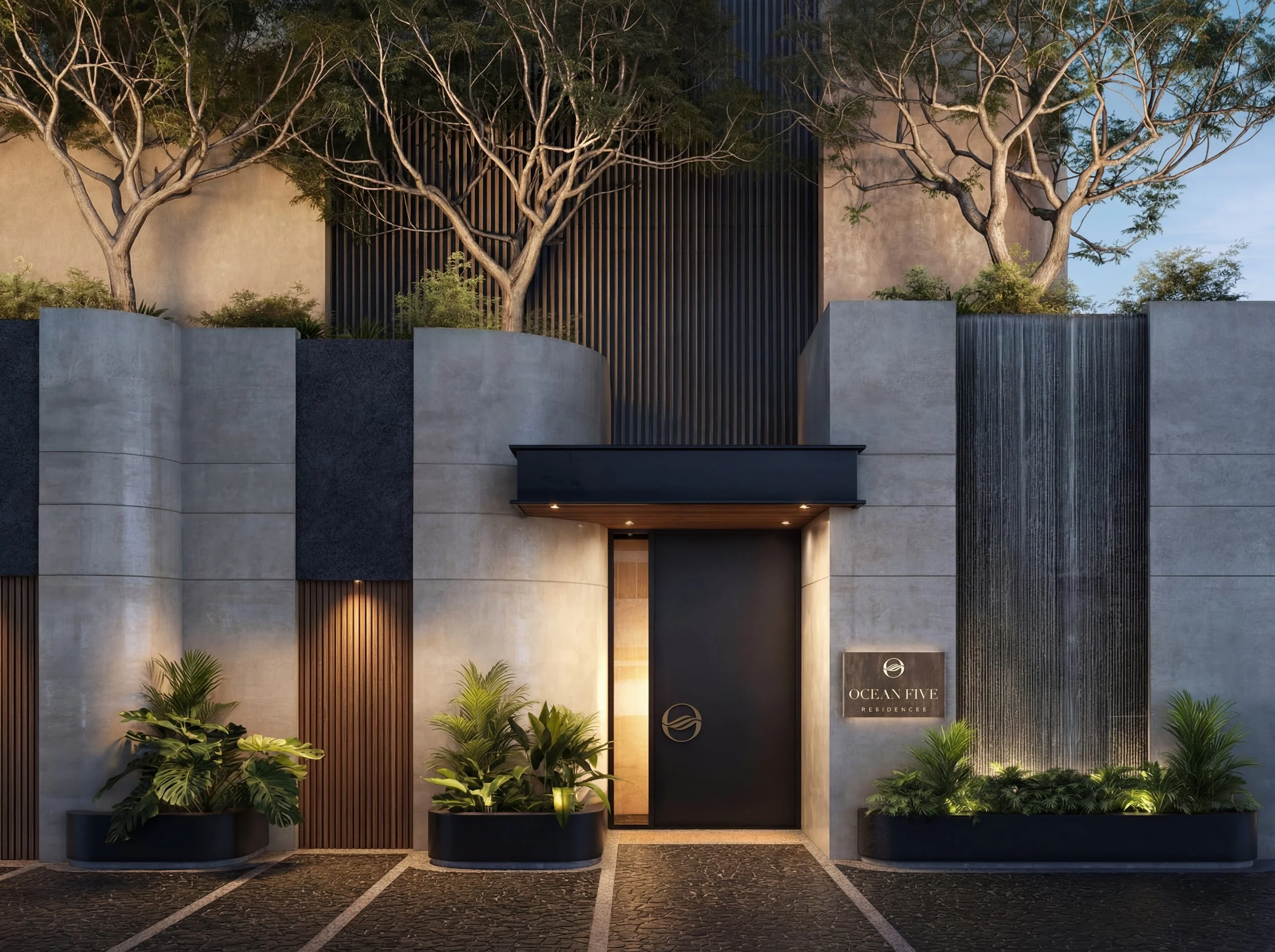 Modern building entrance with large potted plants and trees, sign reading 'Ocean Five Residences'.