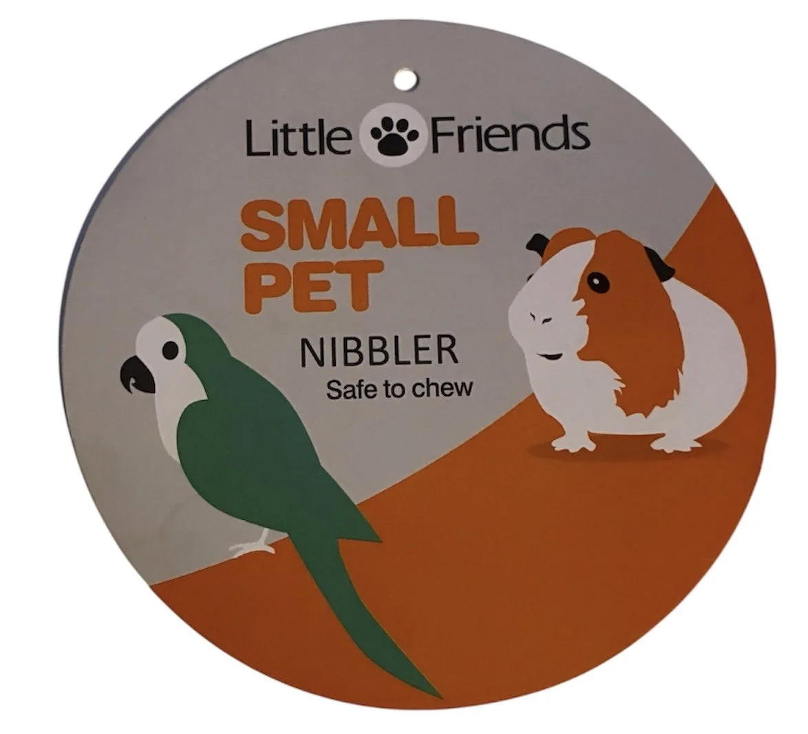 Little Friends Carrot & Corn Loofah Nibbler Hanger product tag showing branding and product information.