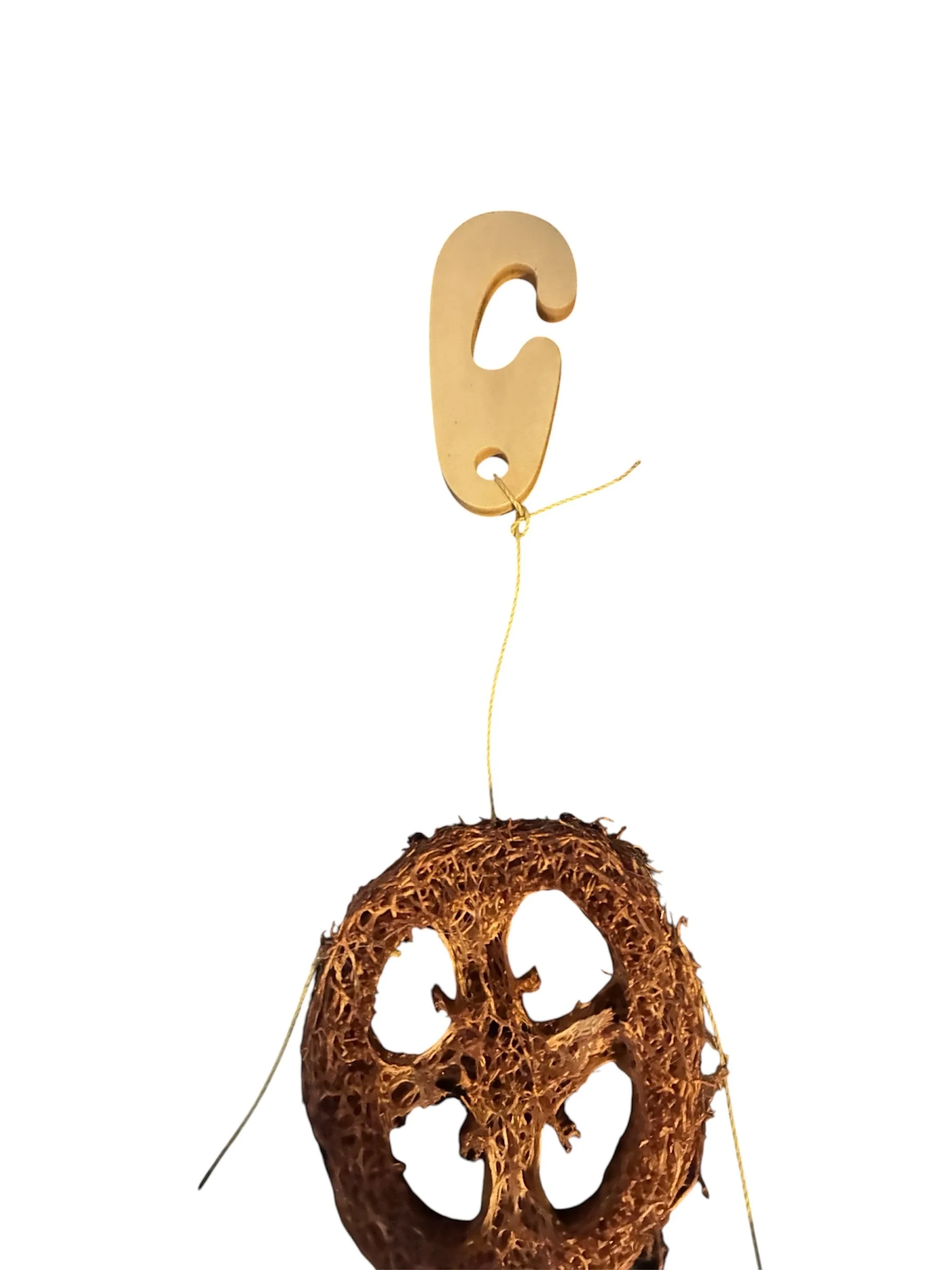Close-up of the wooden hanging hook on the Little Friends Carrot & Corn Loofah Nibbler Hanger.