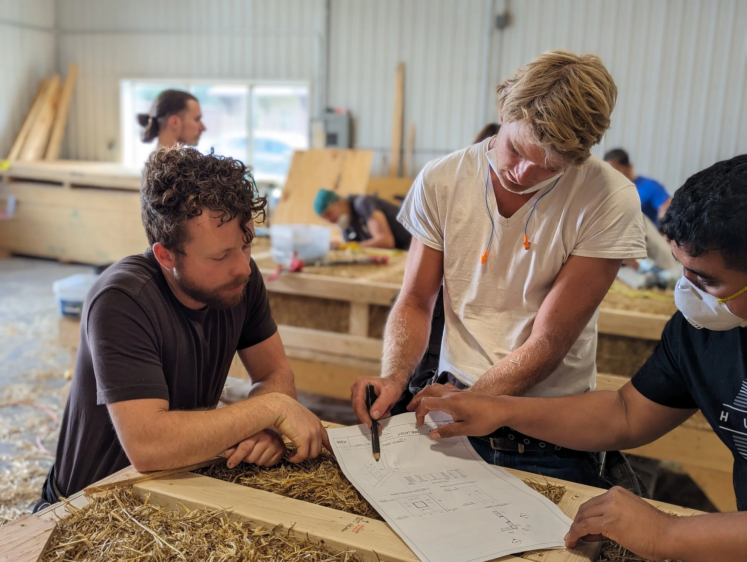 Building Integrity cofounders reviewing prefabricated panel designs together at a Seed Collaborative workshop