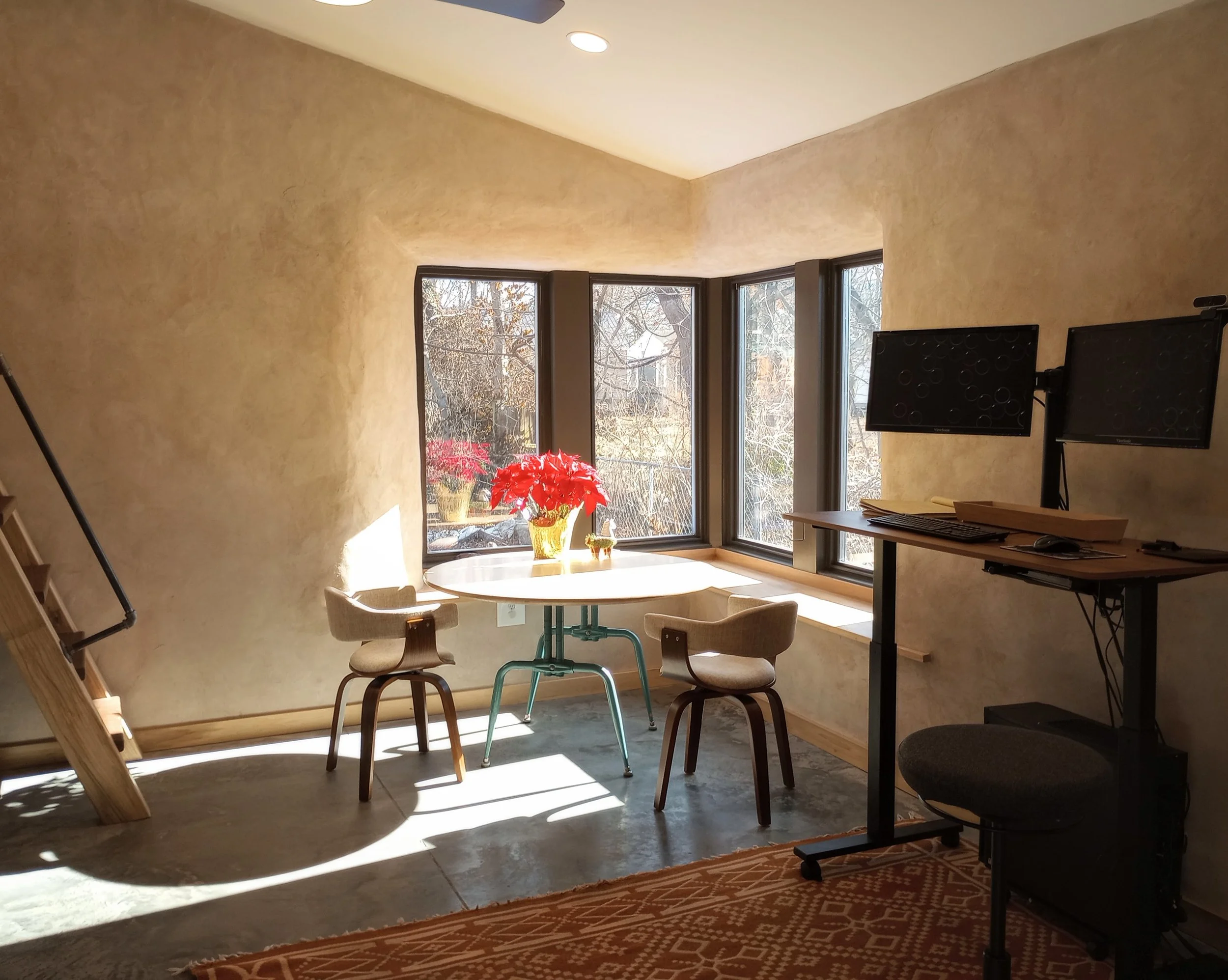 Sun comes through window of straw insulated ADU located in Missouri, a non toxic and natural building material.
