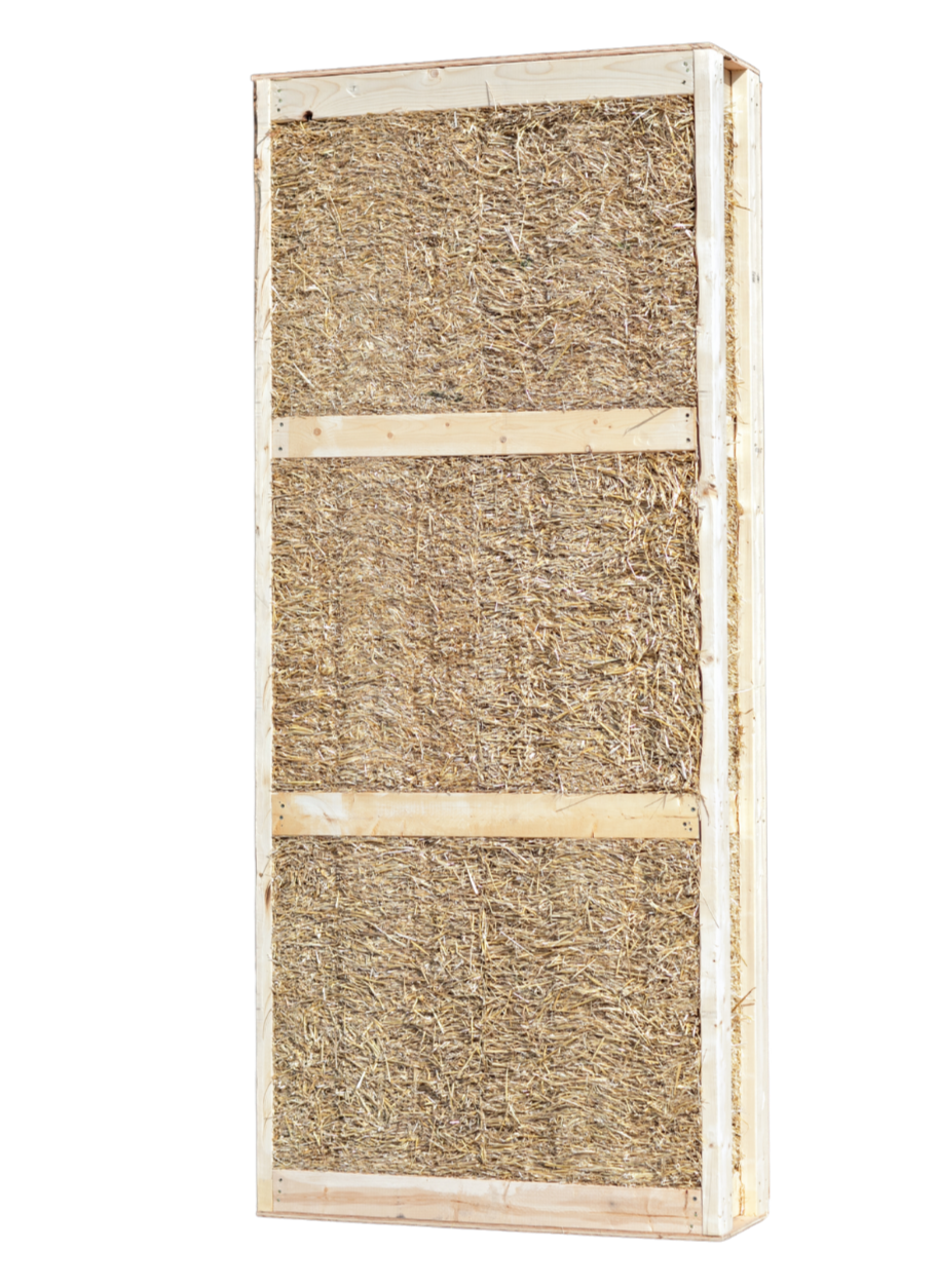 Inside look at a Building Integrity prefabricated straw panel showing the natural straw insulation packed within a wooden structural frame
