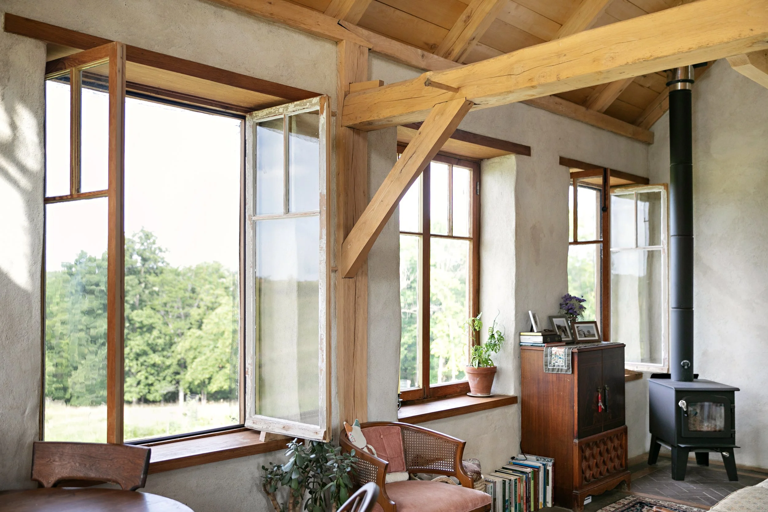 natural building interior featuring deep set windows and smooth natural plaster walls from straw construction