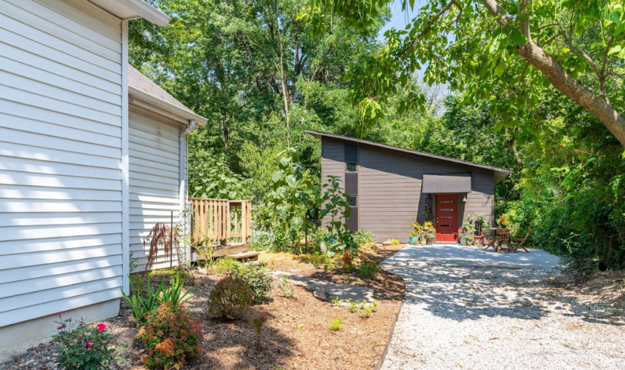Backyard ADU with modern architecture, detached guest house design, energy-efficient accessory dwelling unit, landscaped backyard, and contemporary outdoor living space.
