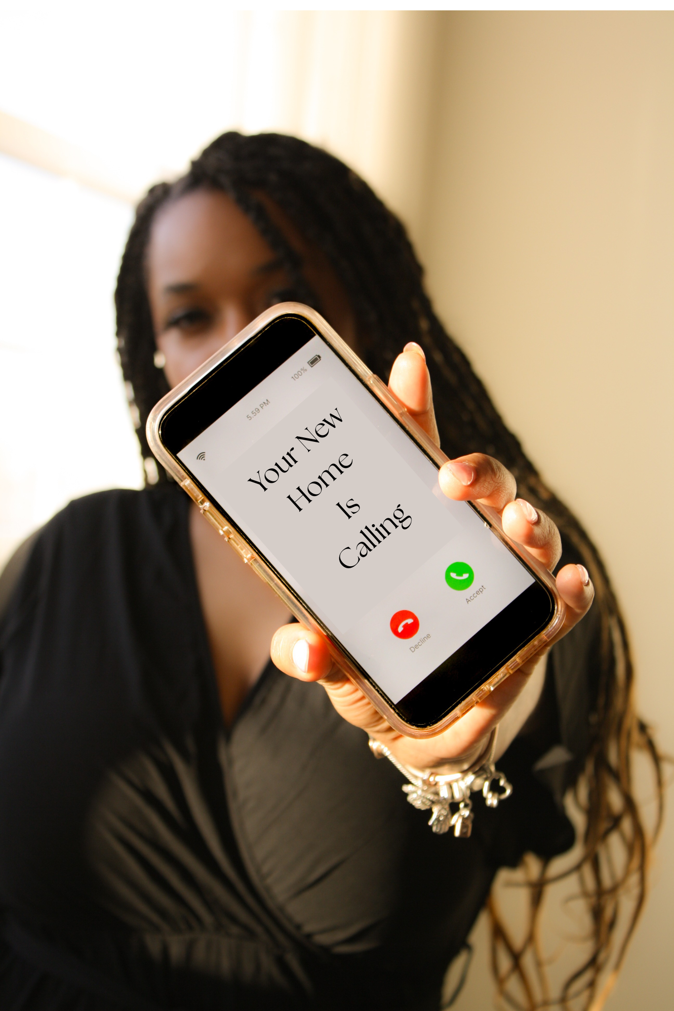 A woman holding a smartphone showing an incoming call with the message "Your New Home Is Calling" on the screen.