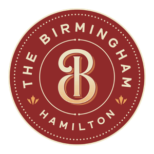 Circular logo with a maroon background, featuring the text 'THE BIRMINGHAM HAMILTON' around the edge and a large stylized letter 'B' in the center.