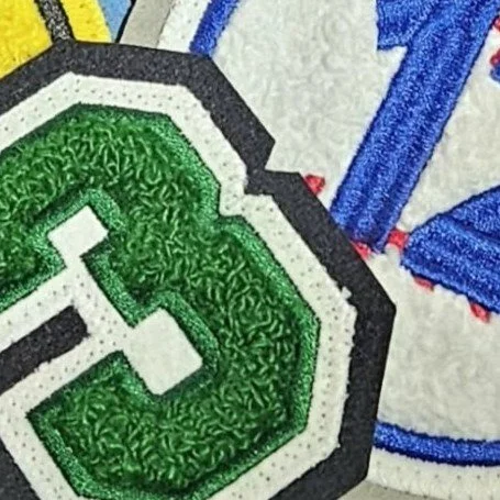 Close-up of a colorful sports embroidered patch on a fabric surface.