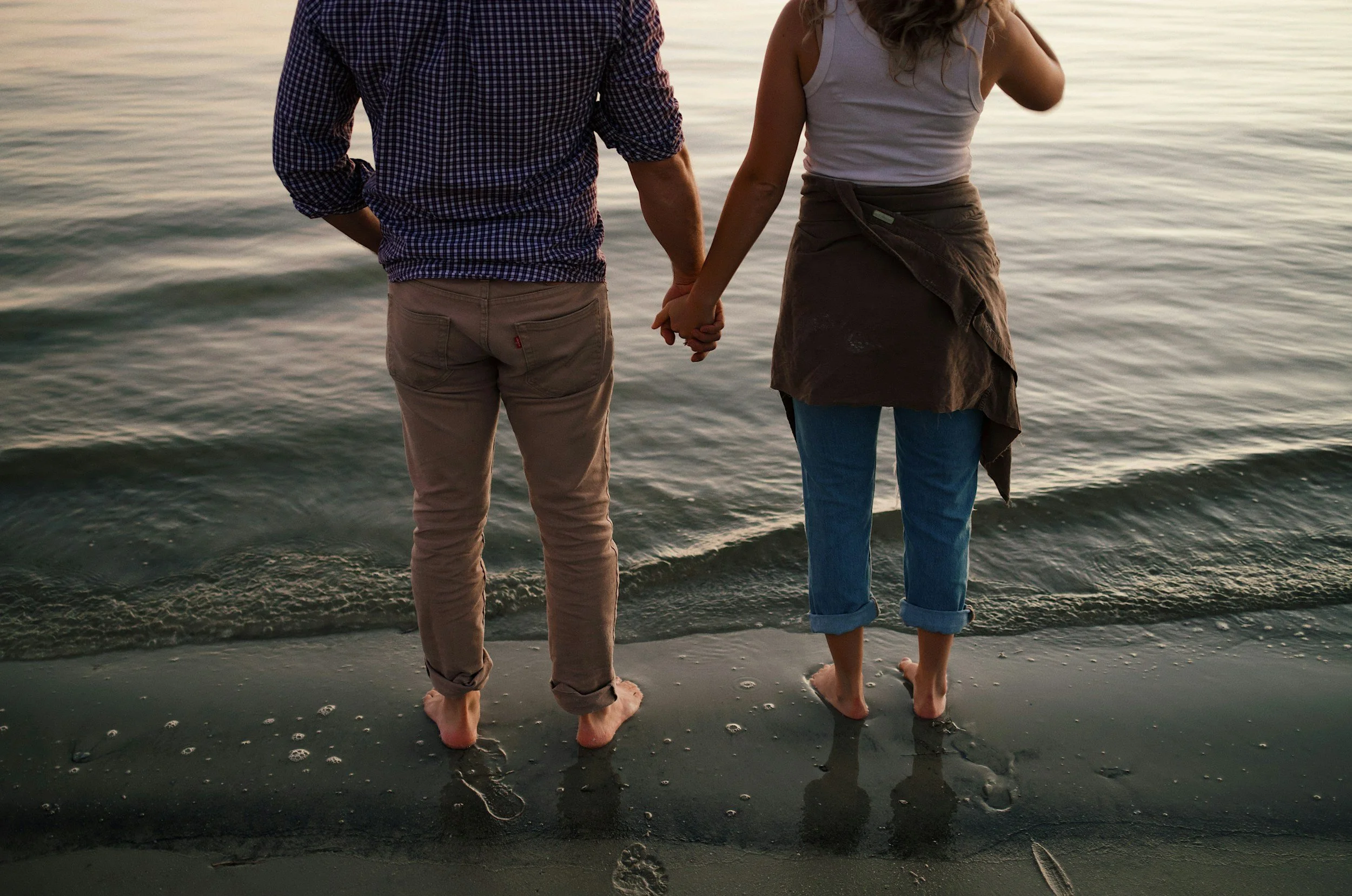 Couple standing near ocean.