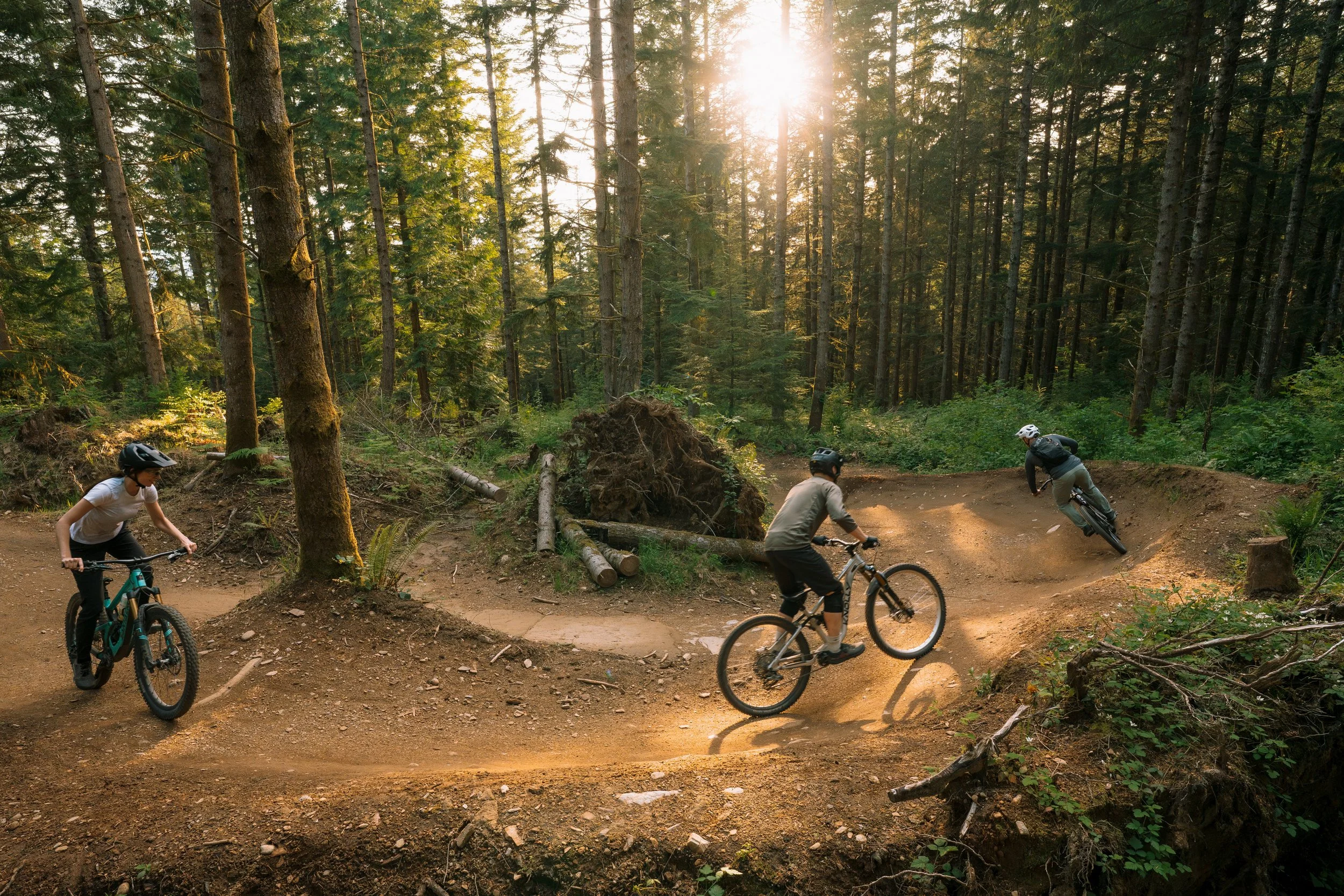 group of riders cornering on trail