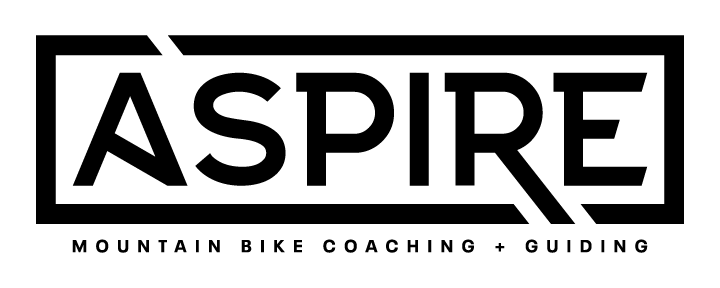Logo with the word 'ASPIRE' in bold uppercase letters, underneath it says 'Mountain Bike Coaching + Guiding'.