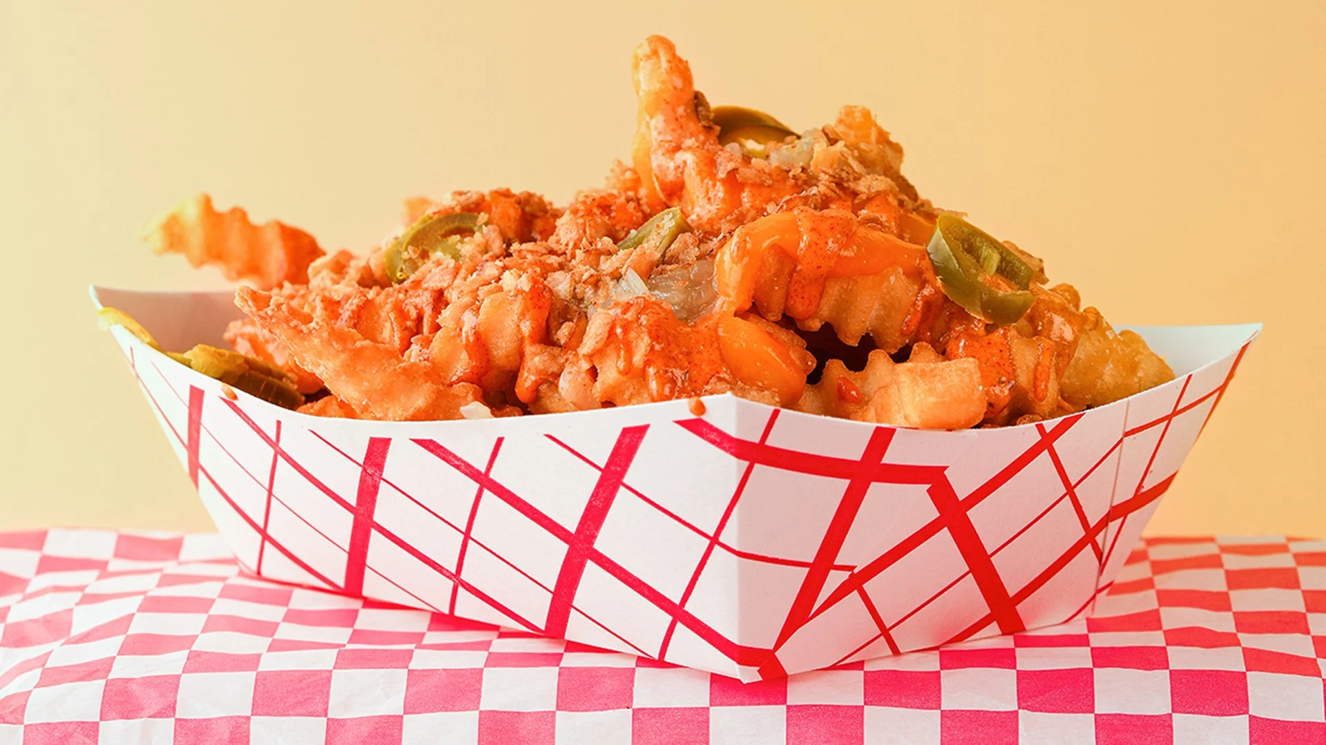 LOADED crinkle fries. Griddled sweet onion, pickled jalapeño, cheese sauce, and QP sauce. Served from our food truck in Midcoast Maine and catering your next event.