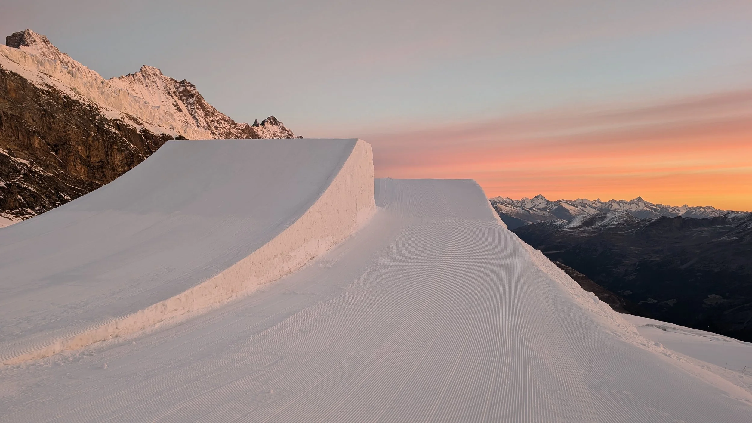 Pristine terrain park jump in Saas Fee. Stomping grounds projects. Sunrise ready for snowboarding and skiing