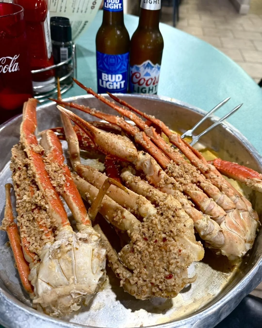 Baked crab legs served in a pan at Kelley's Village Inn