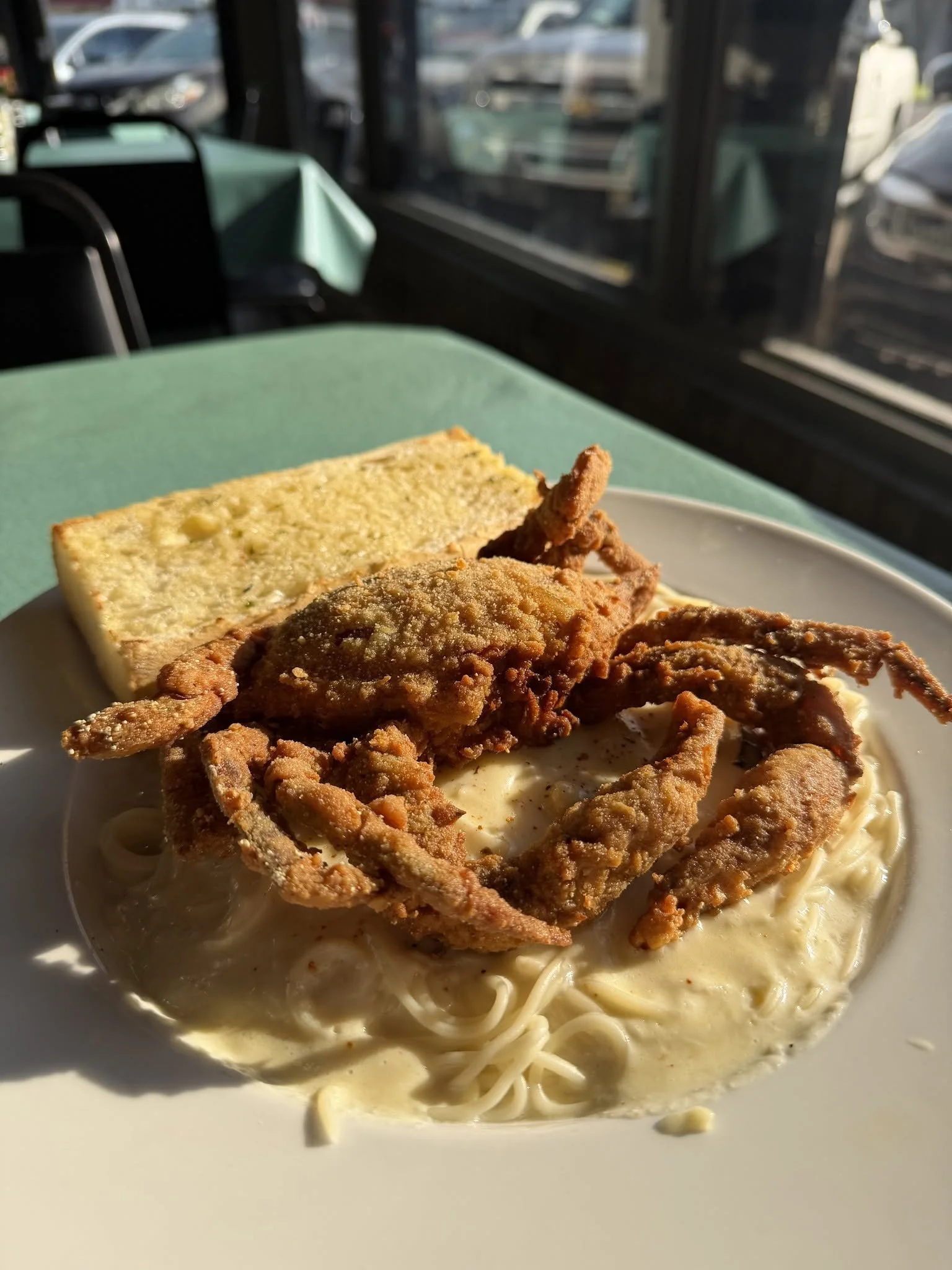 Fried soft-shell crab over pasta with garlic toast at Kelley's Village Inn