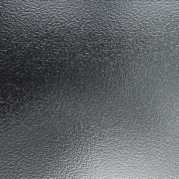 Close-up view of a textured black surface with a bumpy, grainy pattern.