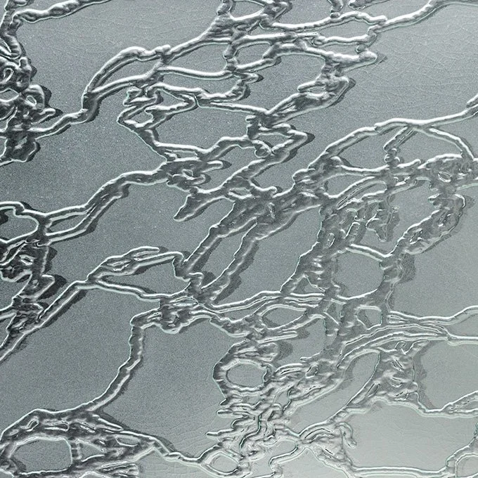 Close-up of silver-colored electrical wiring or tubing with a textured background.