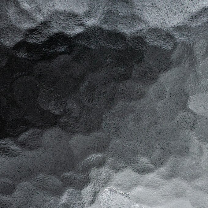 Close-up of a textured black surface with a glossy appearance.