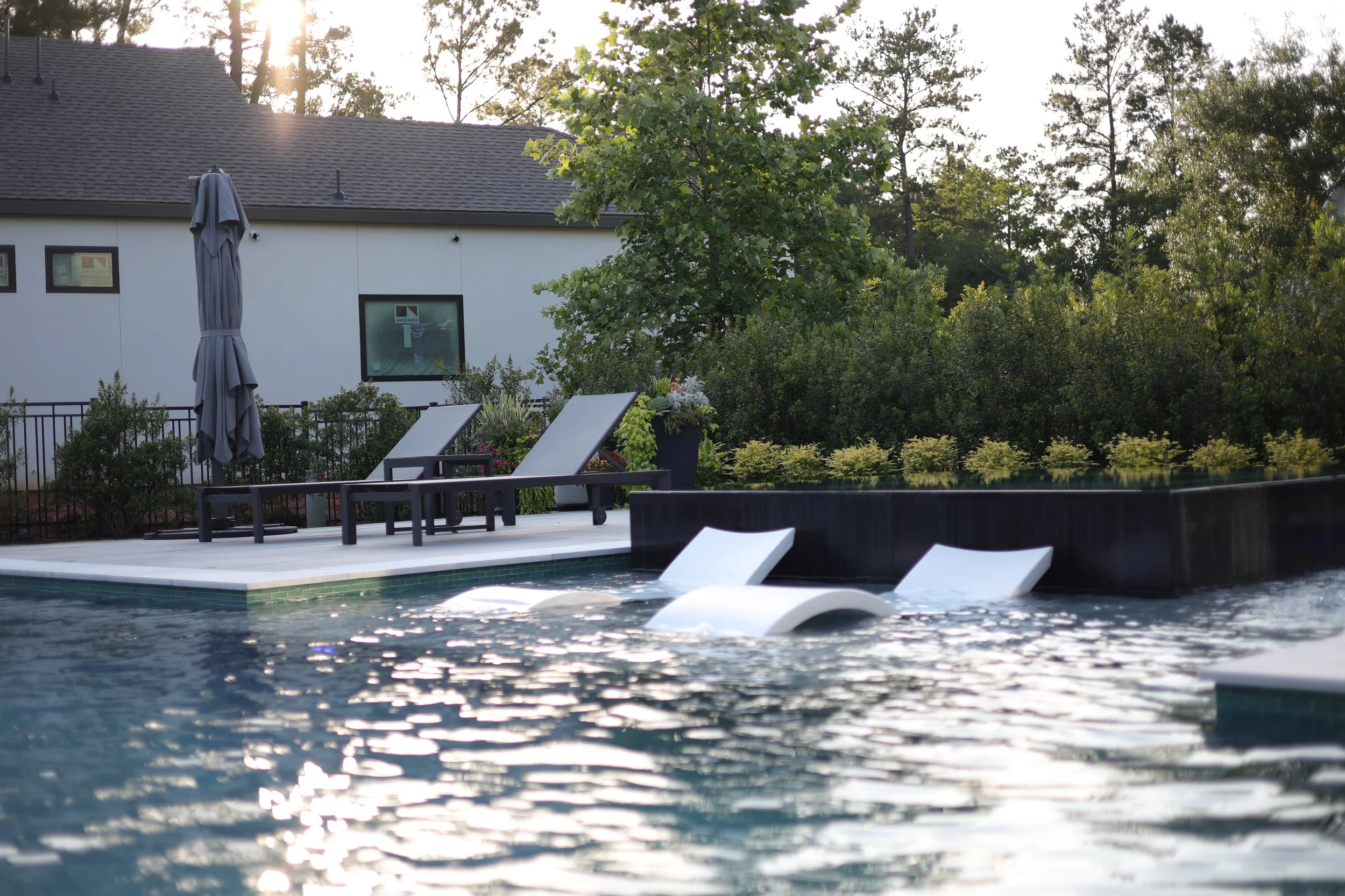 Ledge Loungers sitting inside a pool