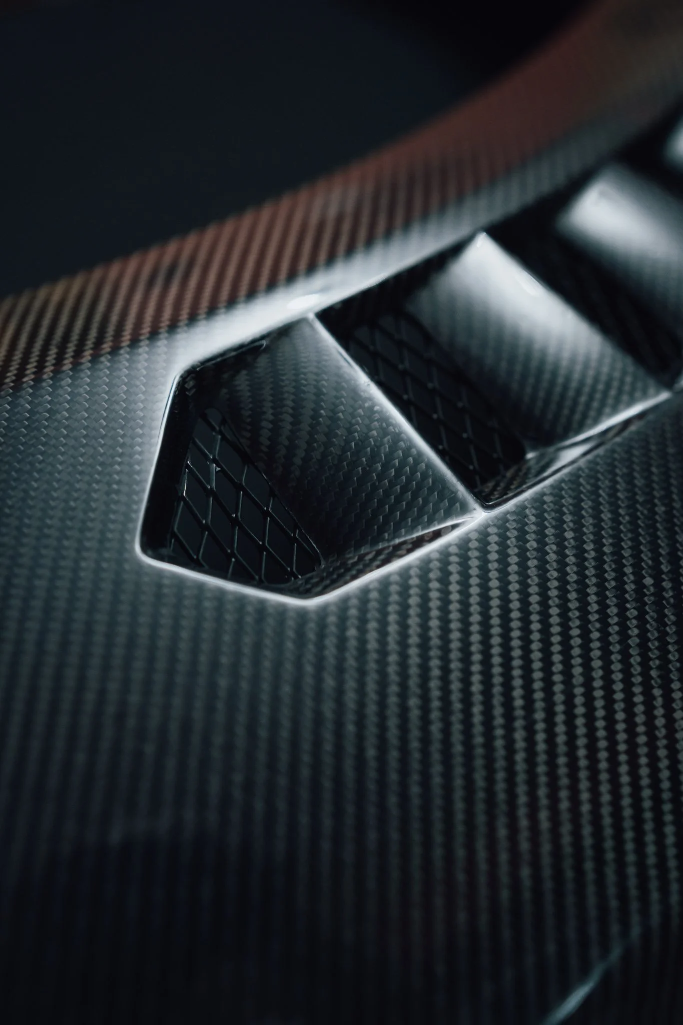 Close-up of a carbon fiber vent on a sports car.
