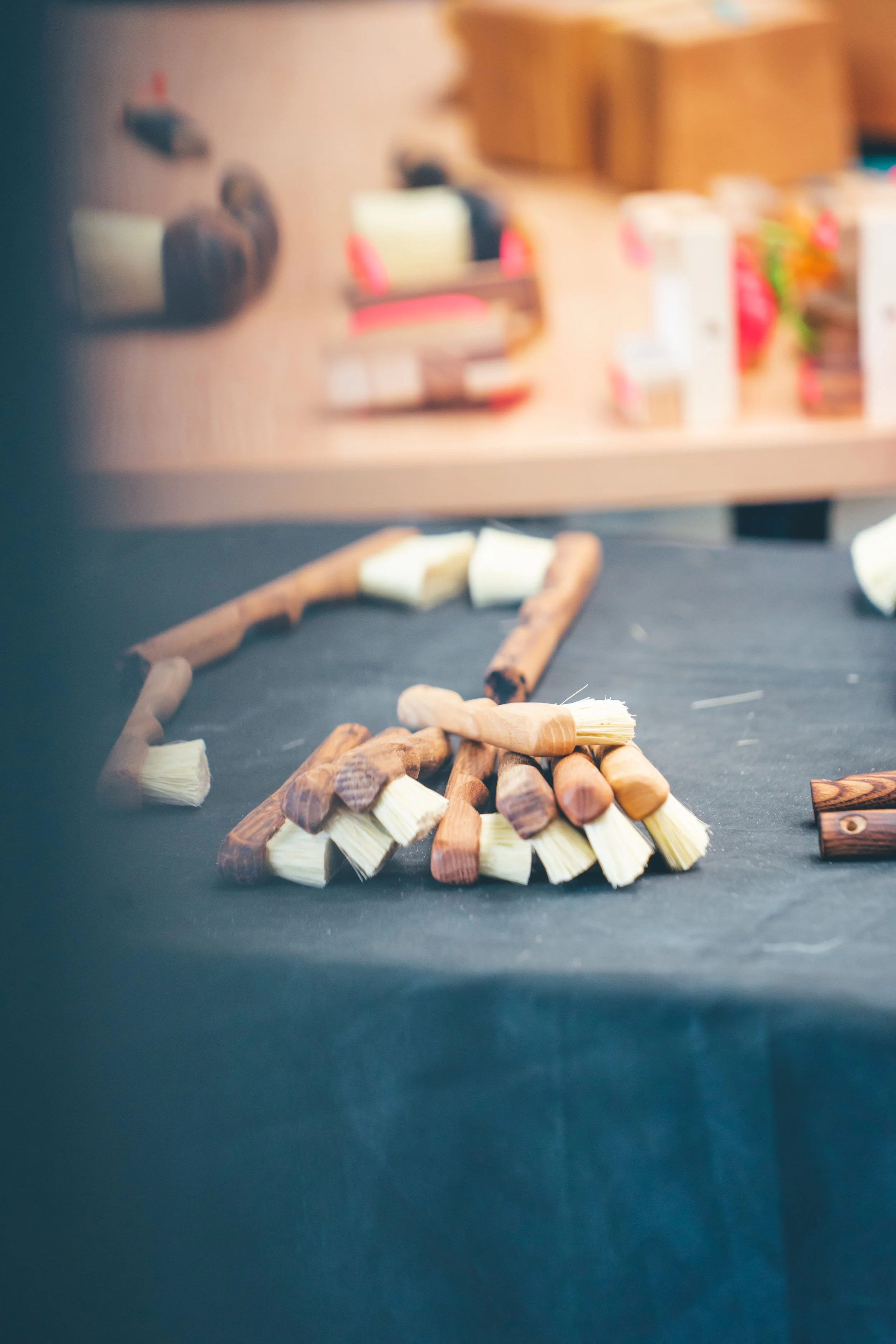 A boat made out of small wooden logs and bristles on a black surface.