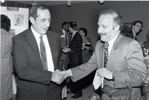 Cuomo
Golden shakes hands with then-Governor Mario Cuomo. It was the second time they met. Their first meeting was at approximately seven o’clock on a Sunday morning outside the Governor’s Mansion on Eagle Street in Albany. Golden was researching a n