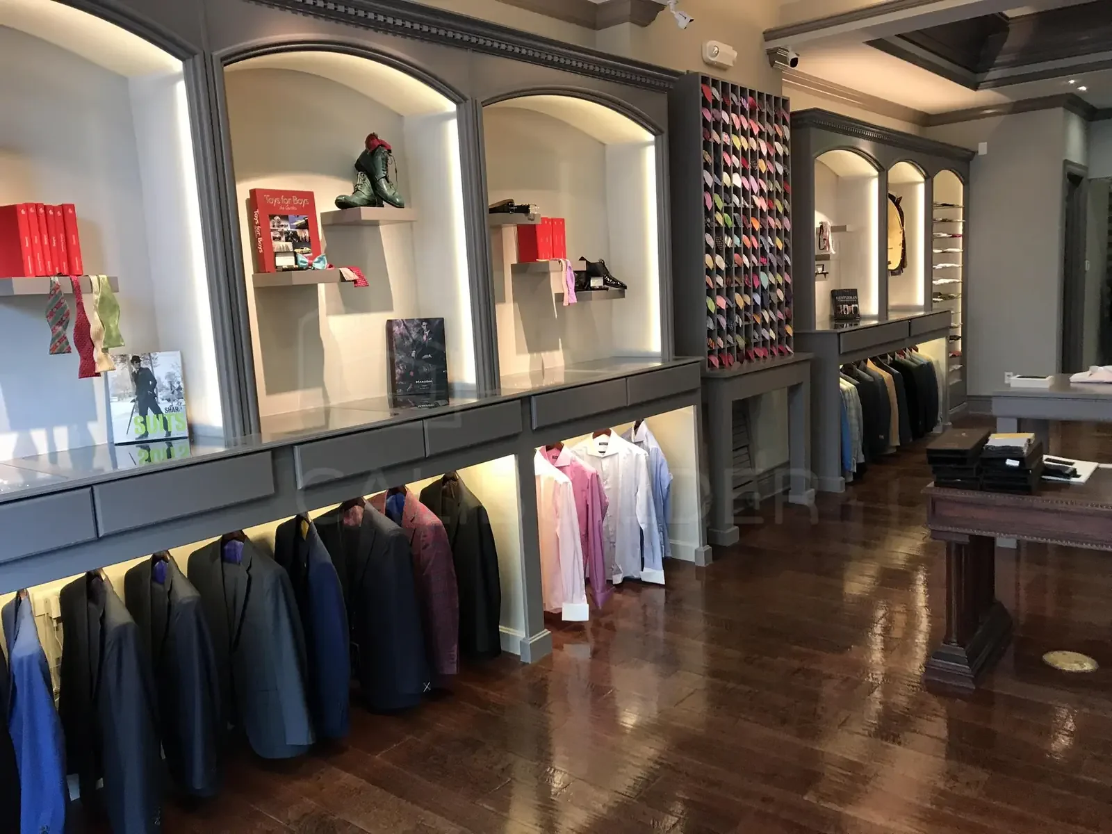 Francouomo retail interior with coordinated millwork, lighting, and finishes by CALIBUILDER