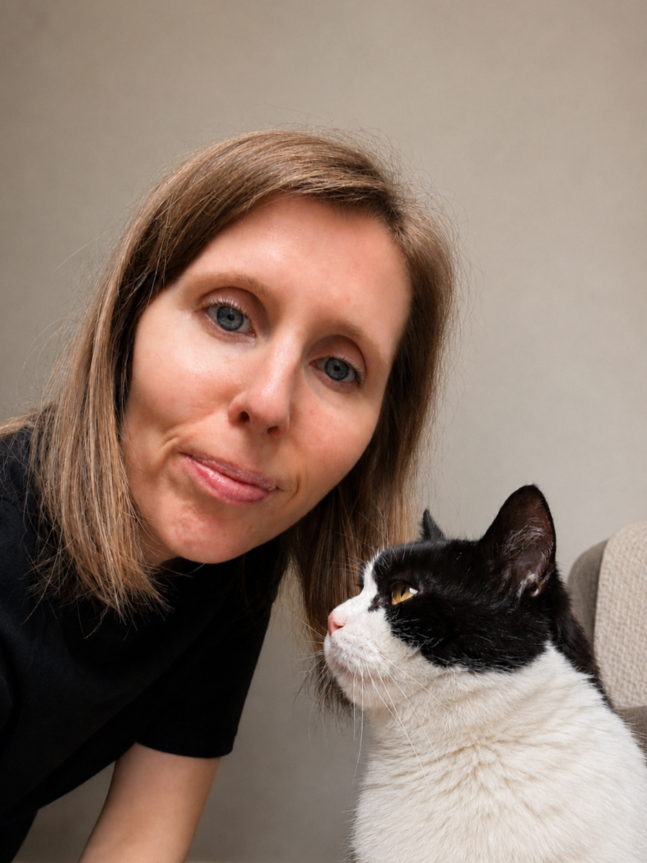 Julie from Greenwich Cat Lady sitting with her black and white cat.