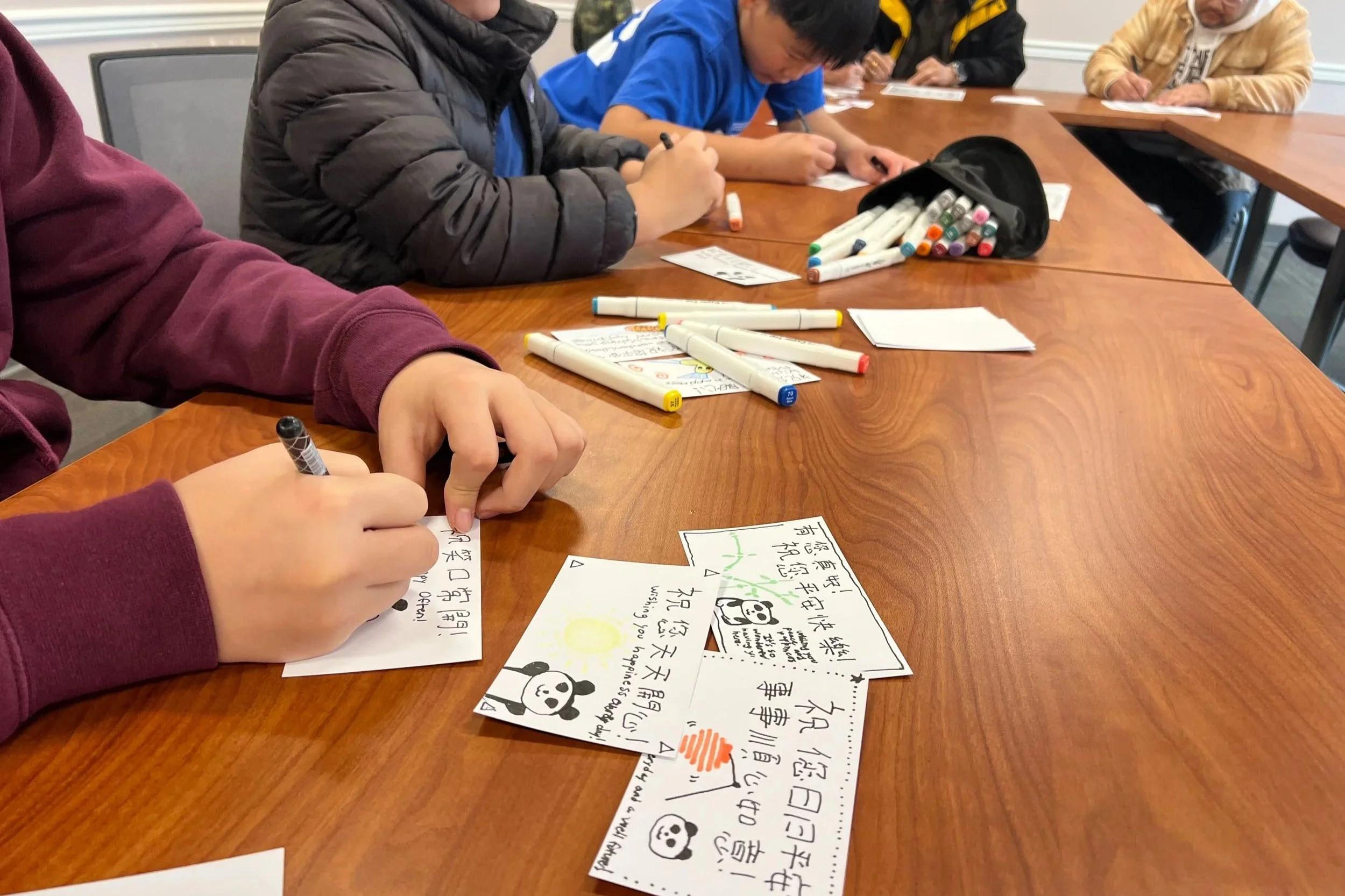 Mid-Hudson Chinese Language Center children writing cards.
