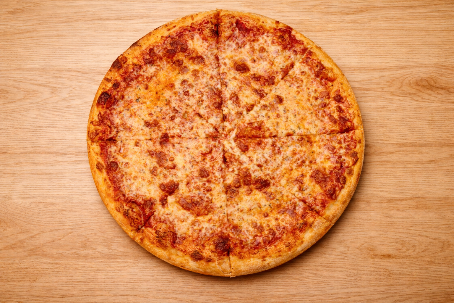 Cheese pizza on a wooden surface