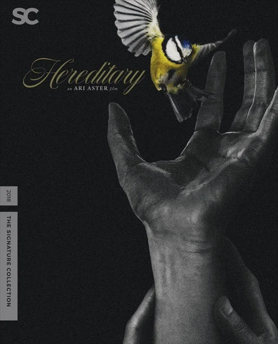 Poster for the film Hereditary featuring a black hand reaching upward towards a small bird with yellow, white, and blue feathers, set against a dark background with gold text.