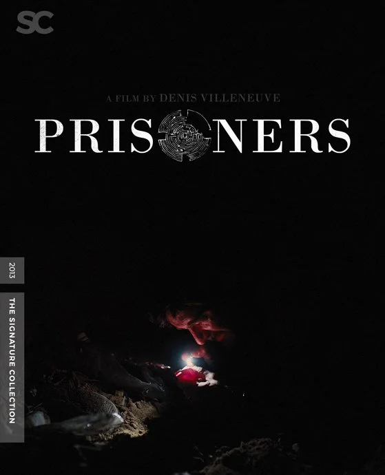 Movie poster for "Prisoners" directed by Denis Villeneuve, featuring a dark background with a small light illuminating a person in a trench coat near an underground tunnel or cave entrance.