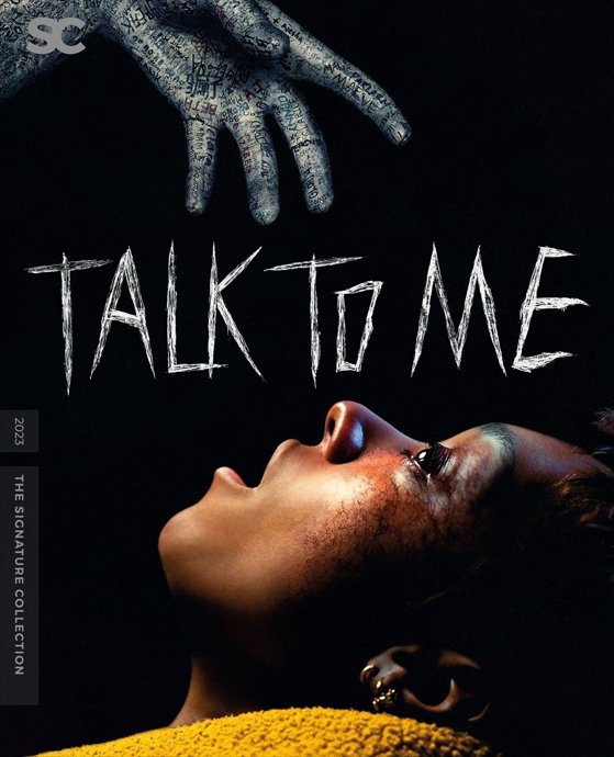 A woman with a bruised face lying down, looking up at a disembodied hand covered in writing reaching from the top. The words 'TALK TO ME' are written in chalk-like letters above her. The image evokes a dark, mysterious atmosphere.